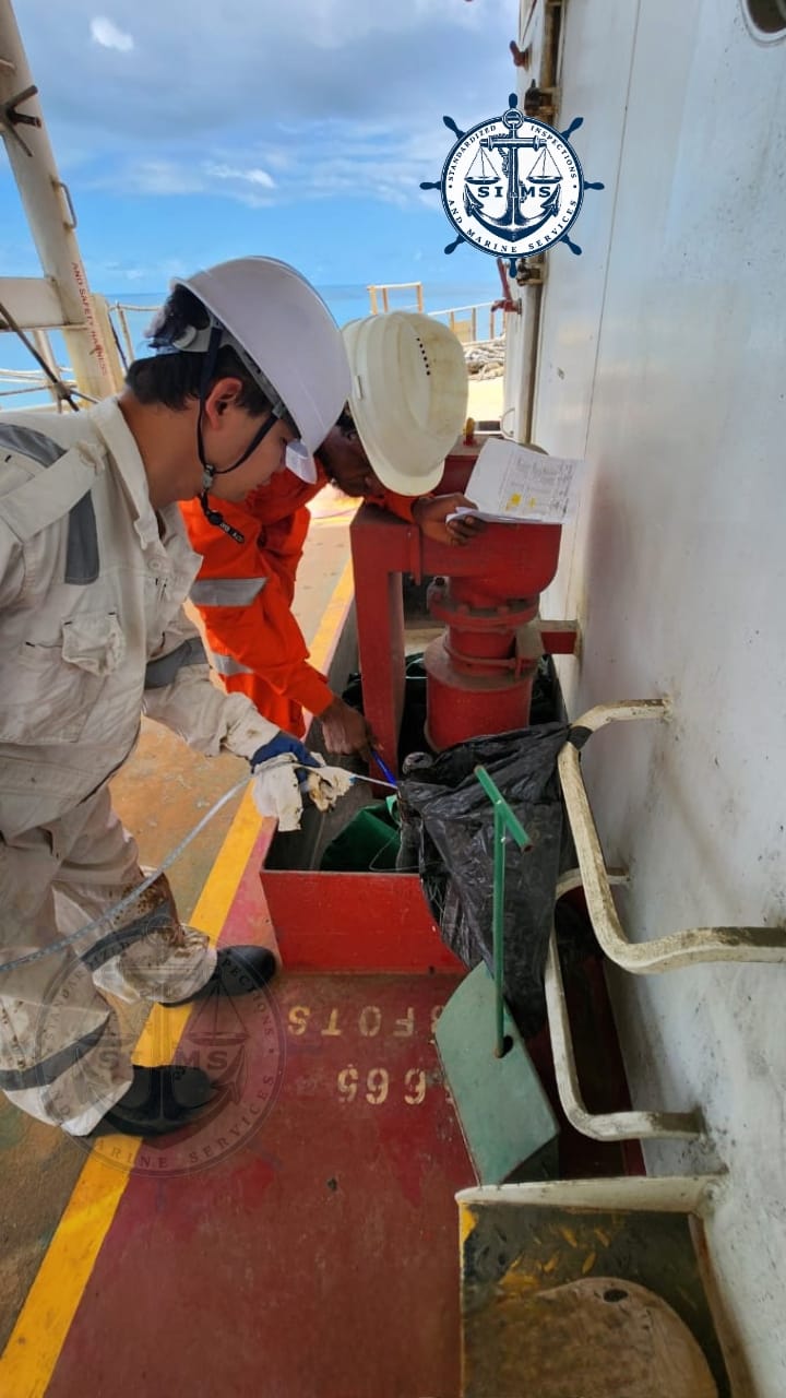Surveyors on deck reviewing tank readings during a bunker survey