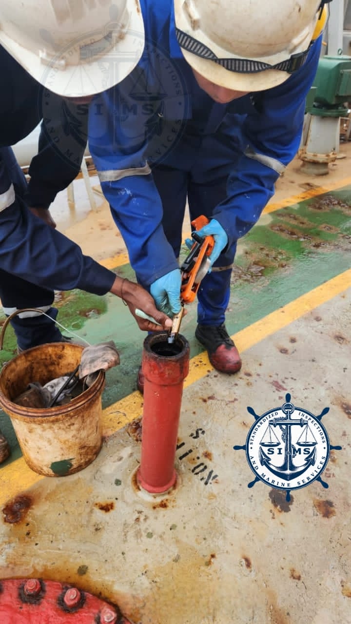 Surveyors drawing a bunker fuel sample on deck