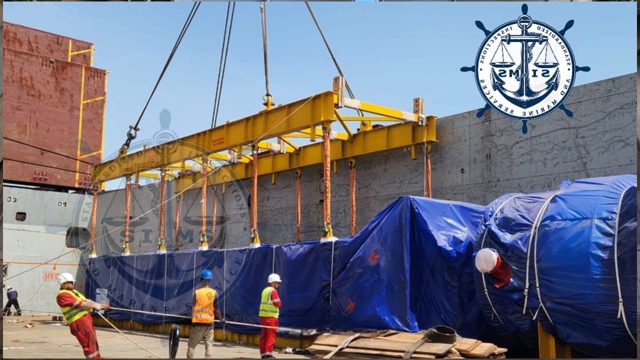 Lifting frame positioned over cargo alongside the vessel