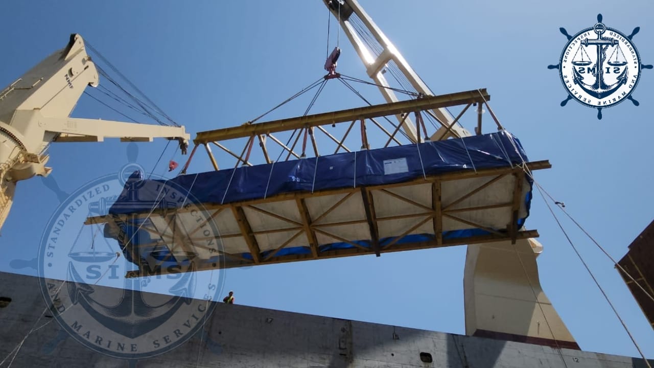 Timber-cased cargo lifted clear of the hold coaming